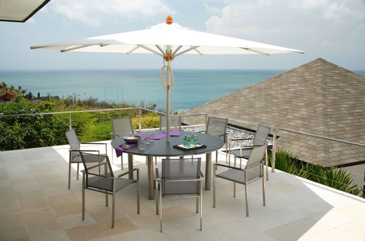 Barlow Tyrie 13' Pulley Lift Umbrella Shown With Base, Inside An Equinox 71" Dining Table