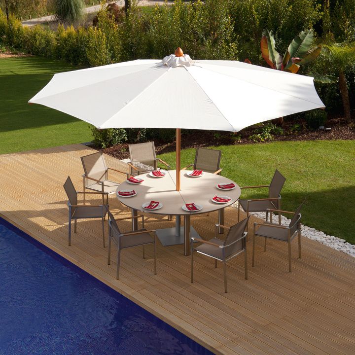 Barlow Tyrie Equinox 71" Round Ceramic Top Dining Shown With 8 Mercury Arm Chairs, A 13ft. Umbrella And Base.