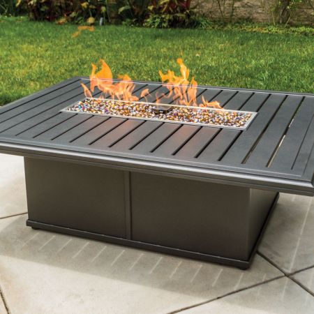 Tropitone Banchetto 54X42 Rectangular Fire Pit Lit On The Patio.